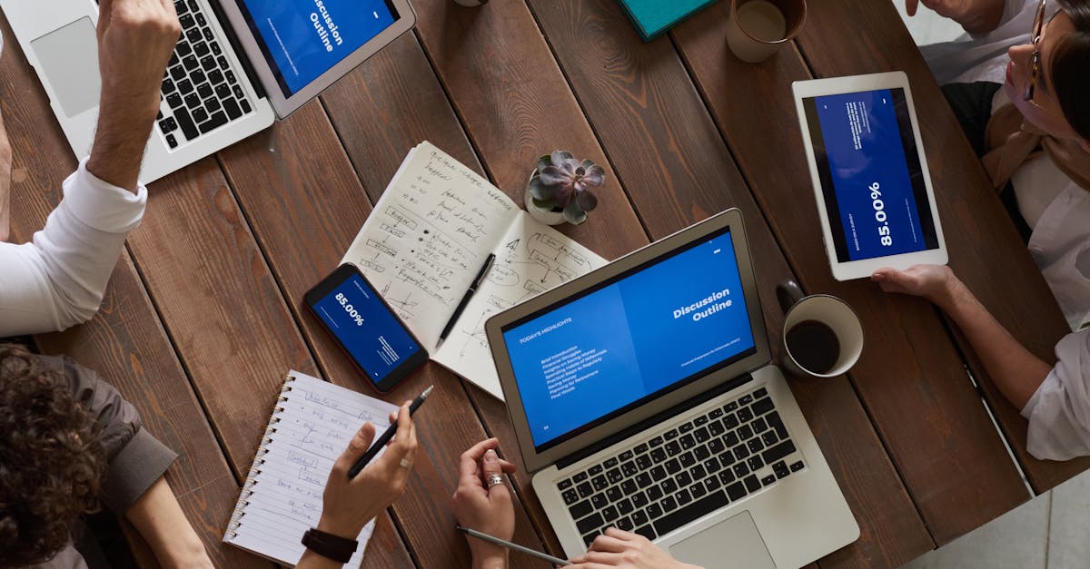 A cheerful woman in a blue sweater working remotely with a laptop in a cozy home setting.