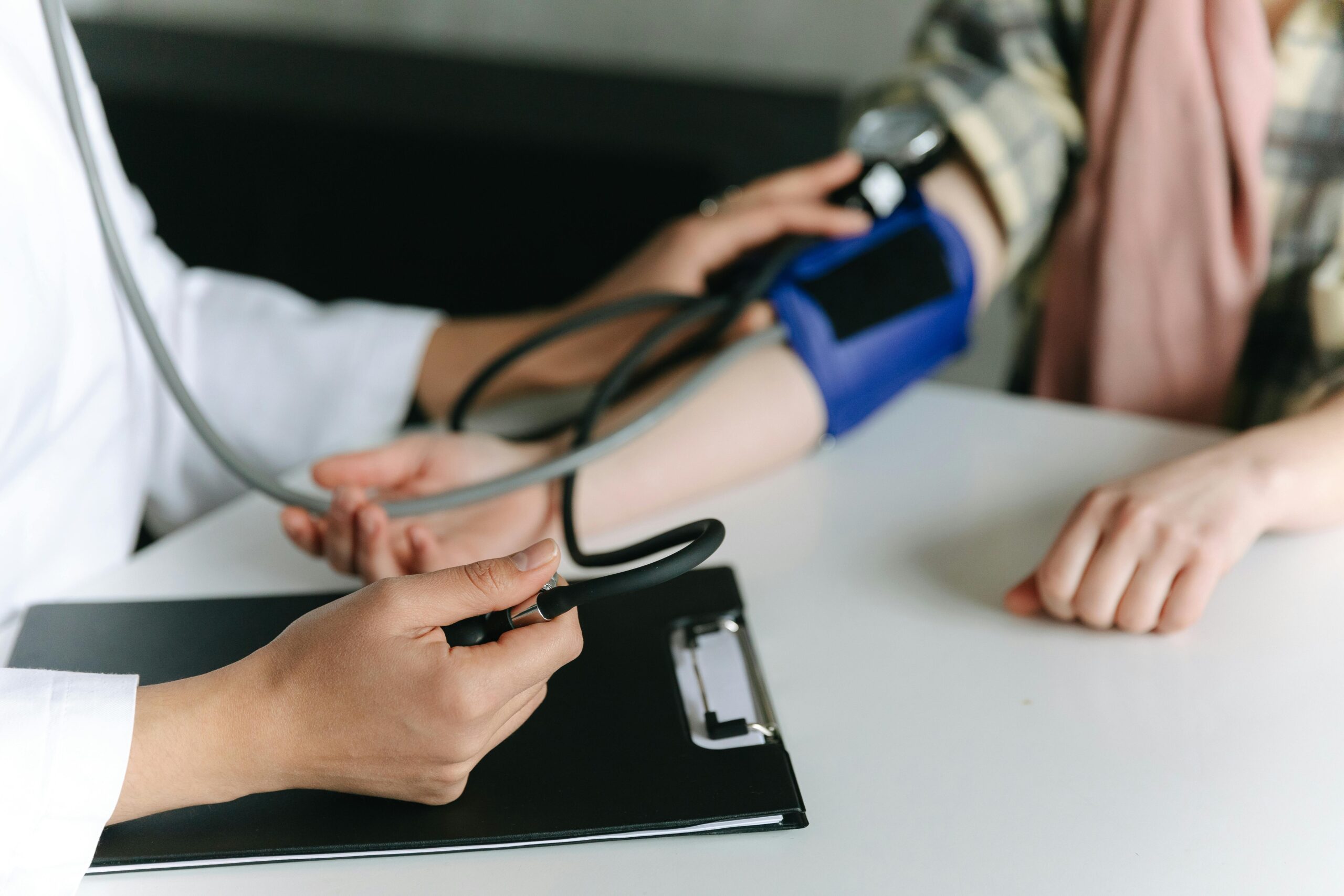 A Healthcare Worker Measuring a Patient's Blood Pressure Using a Sphygmomanometer